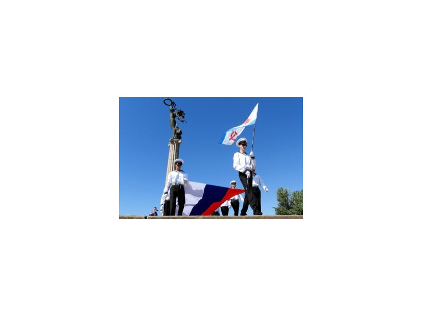 ウクライナ南部・ヘルソン州でロシア国旗を掲げ歩く青年組織員ら＝7月（タス＝共同）