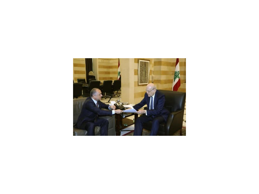 11日、イスラエルとの海洋境界画定の最終案を交渉担当の高官から受け取るレバノンのミカティ首相（右）＝ベイルート（AP＝共同）