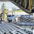 トンガのファアモツ国際空港で、航空自衛隊のC130輸送機から降ろされる支援物資＝29日（防衛省統合幕僚監部提供）