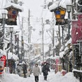 雪が降り続く中、滋賀県長浜市内を歩く人たち＝5日午後