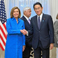 朝食会を前にペロシ米下院議長（左）と握手をする岸田首相＝5日午前、首相公邸（代表撮影）