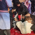 ソウル・梨泰院で起きた事故の現場付近で、介抱される人＝30日未明（共同）