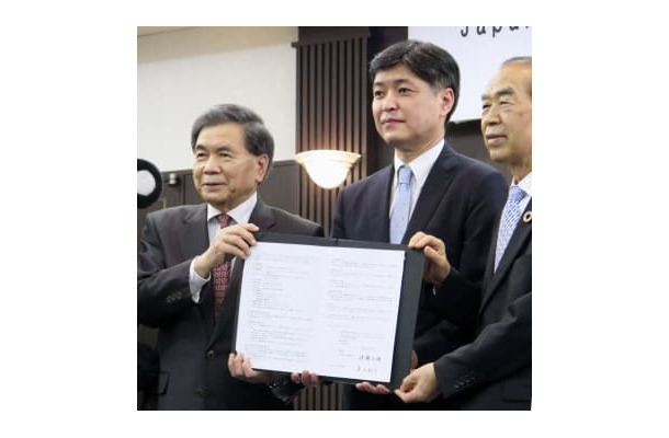 立地協定を結び、記念撮影に応じる「JASM」の堀田祐一社長（中央）ら＝19日午後、熊本市